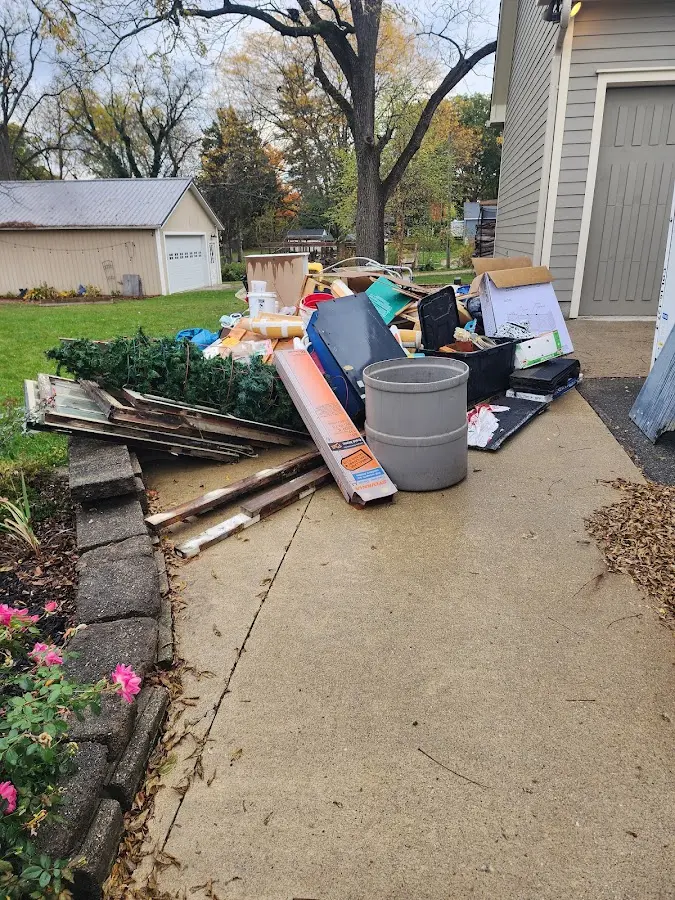 Dumpster being loaded with debris for Commercial Dumpster Rental in Midvale